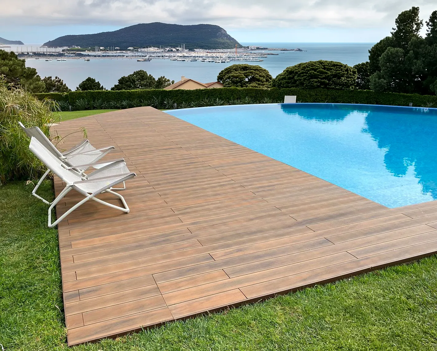 CDECK composite decking around a swimming pool, American Walnut colour