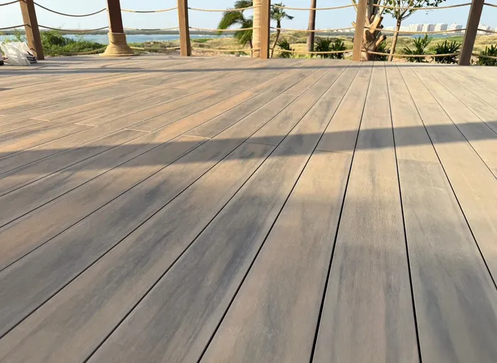Terrasse composite menant vers le lagon, avec la ligne d'horizon de la ville en arrière-plan.
