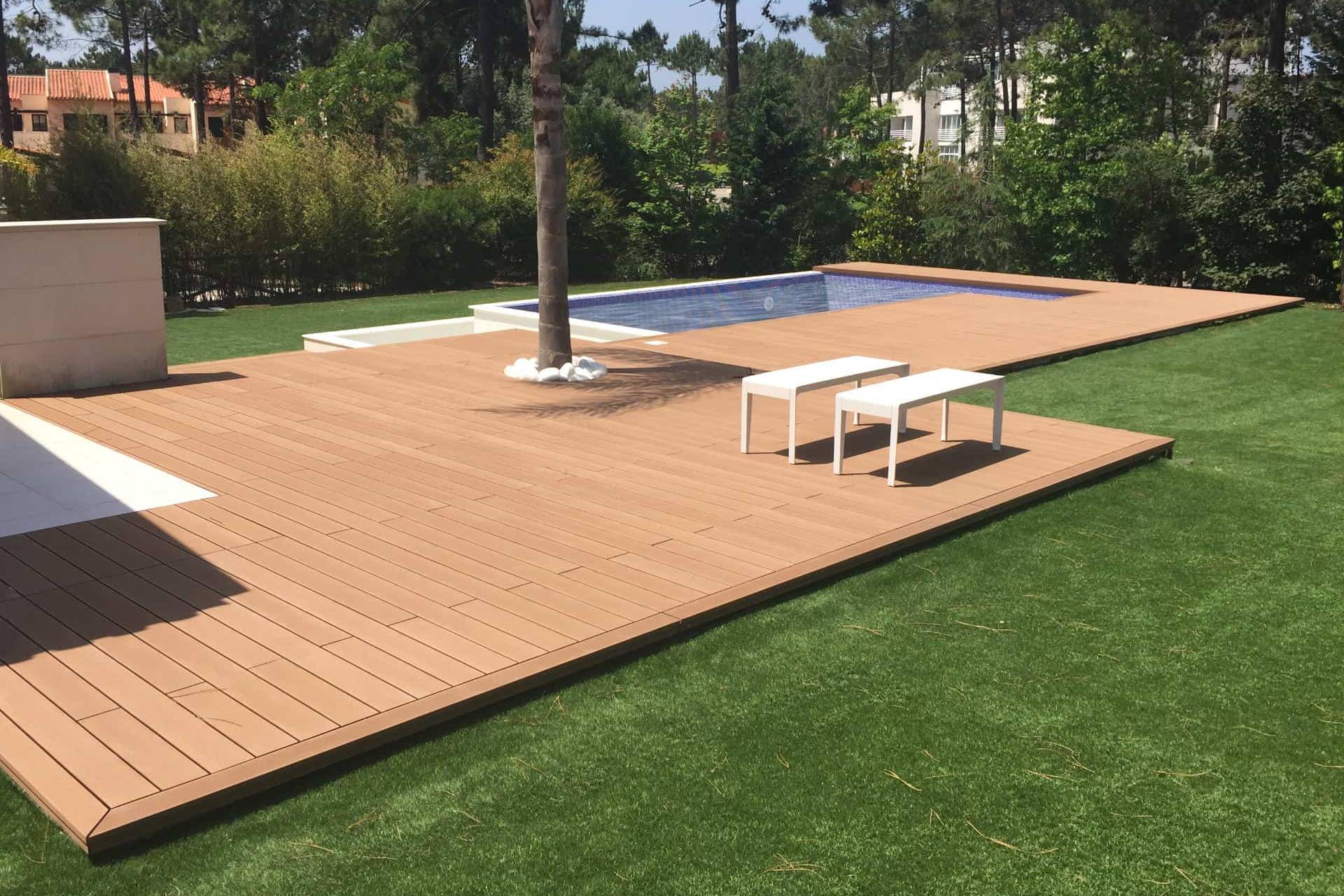 CDECK composite decking in redwood colour in a pool and garden area