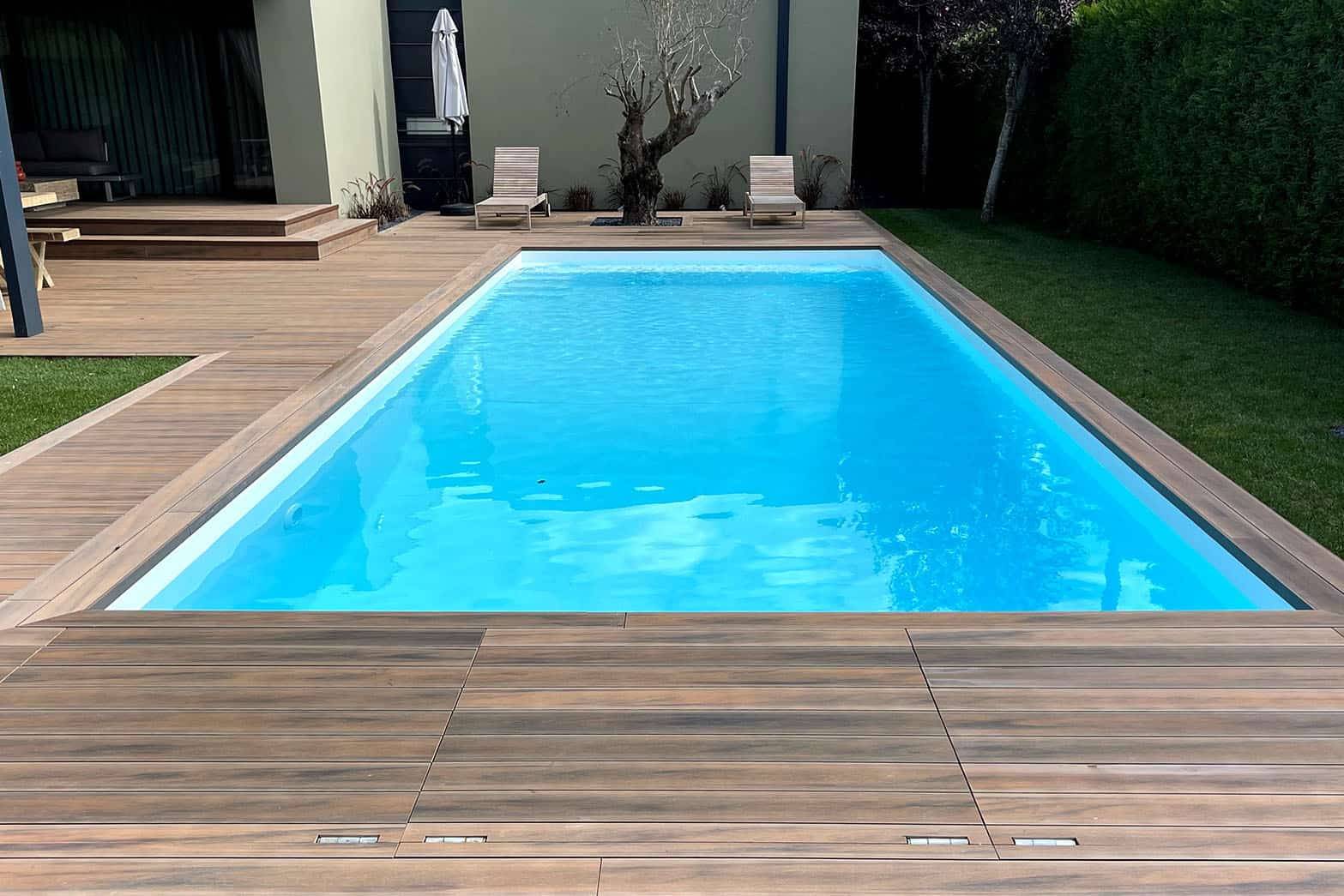 CDECK WUUDE composite decking in Soft Oak around a pool area 