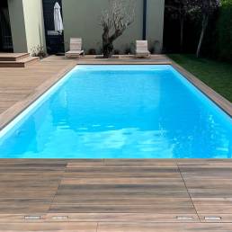 CDECK WUUDE composite decking in Soft Oak around a pool area 