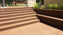CDECK Original composite decking in redwood colour installed on stairs and in a garden