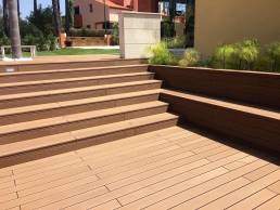 CDECK Original composite decking in redwood colour installed on stairs and in a garden