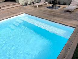 CDECK WUUDE composite decking in soft oak colour in a pool area