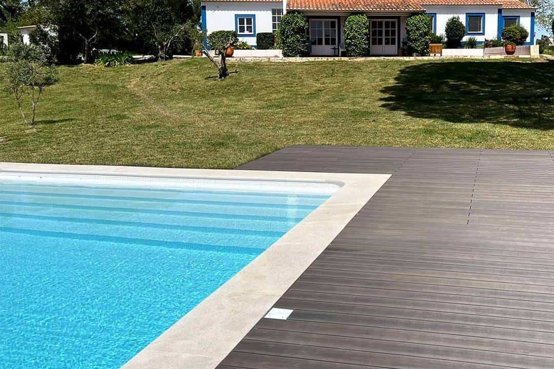 CDECK WUUDE composite decking in dark walnut colour in a pool area