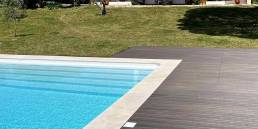 CDECK WUUDE composite decking in dark walnut colour in a pool area