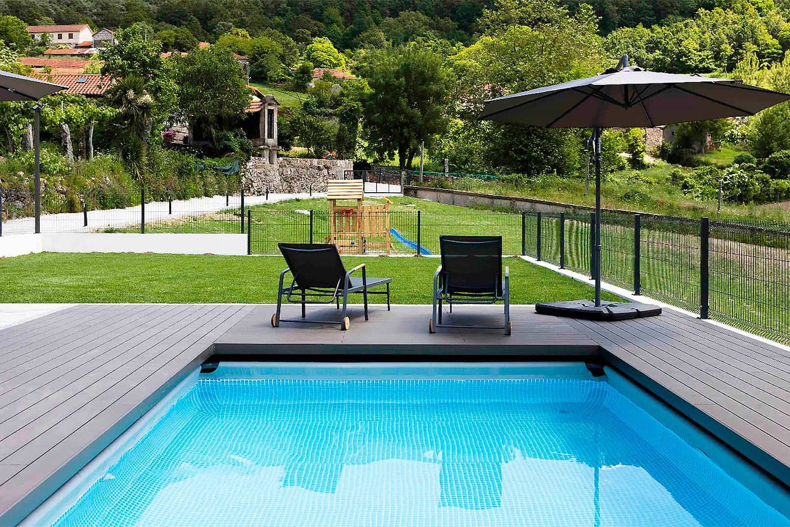 CDECK composite decking in Dark Black in a pool and garden area