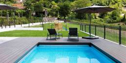 CDECK composite decking in Dark Black in a pool and garden area