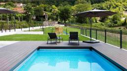 CDECK composite decking in Dark Black in a pool and garden area