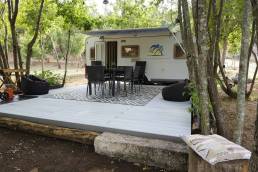 CDECK WUUDE composite decking in Nordic oak colour on flooring next to a caravan