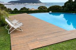 CDECK WUUDE composite decking in American walnut colour in a pool area