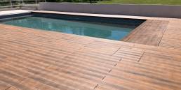 CDECK WUUDE composite decking in American walnut colour in a pool area