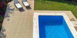 CDECK Original composite decking in beige beech colour in a pool area