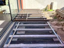 Composite decking installation with aluminium supports in a garden