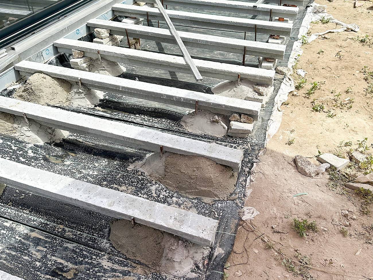Composite decking installation with aluminium supports in a garden