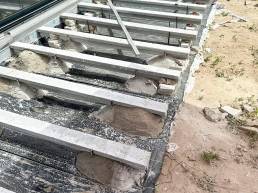 Composite decking installation with aluminium supports in a garden