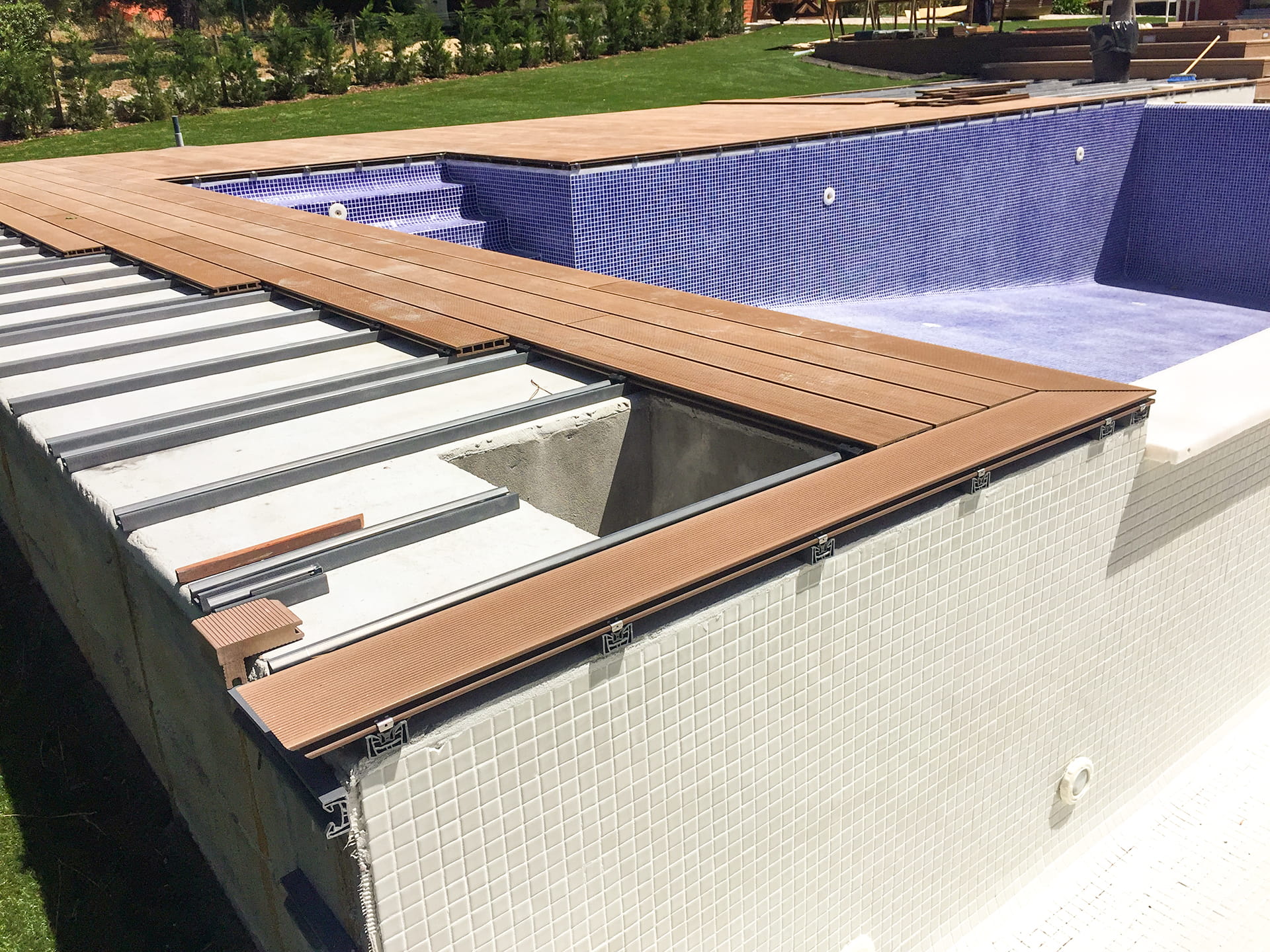 CDECK composite decking installation in Redwood in a garden