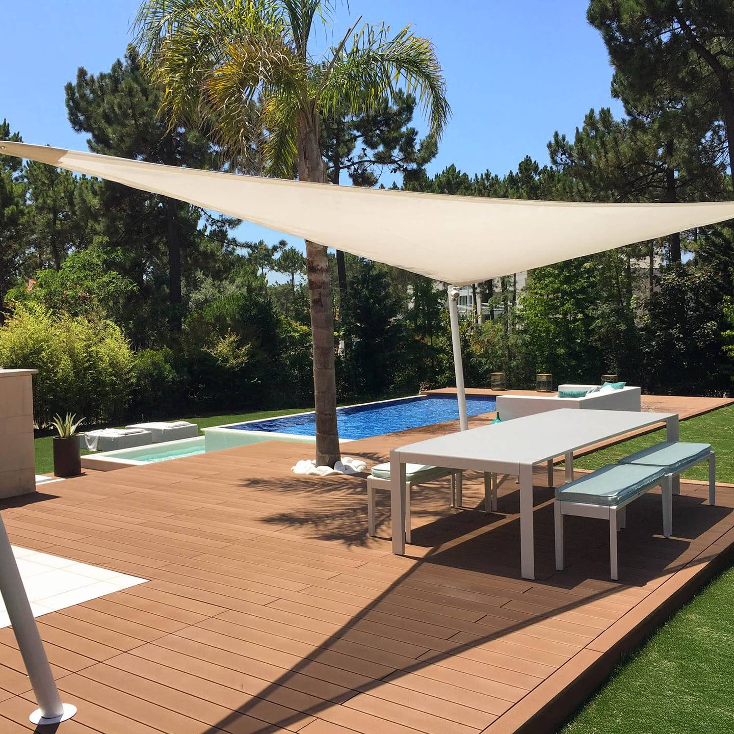 CDECK composite decking in Redwood in a garden and pool area