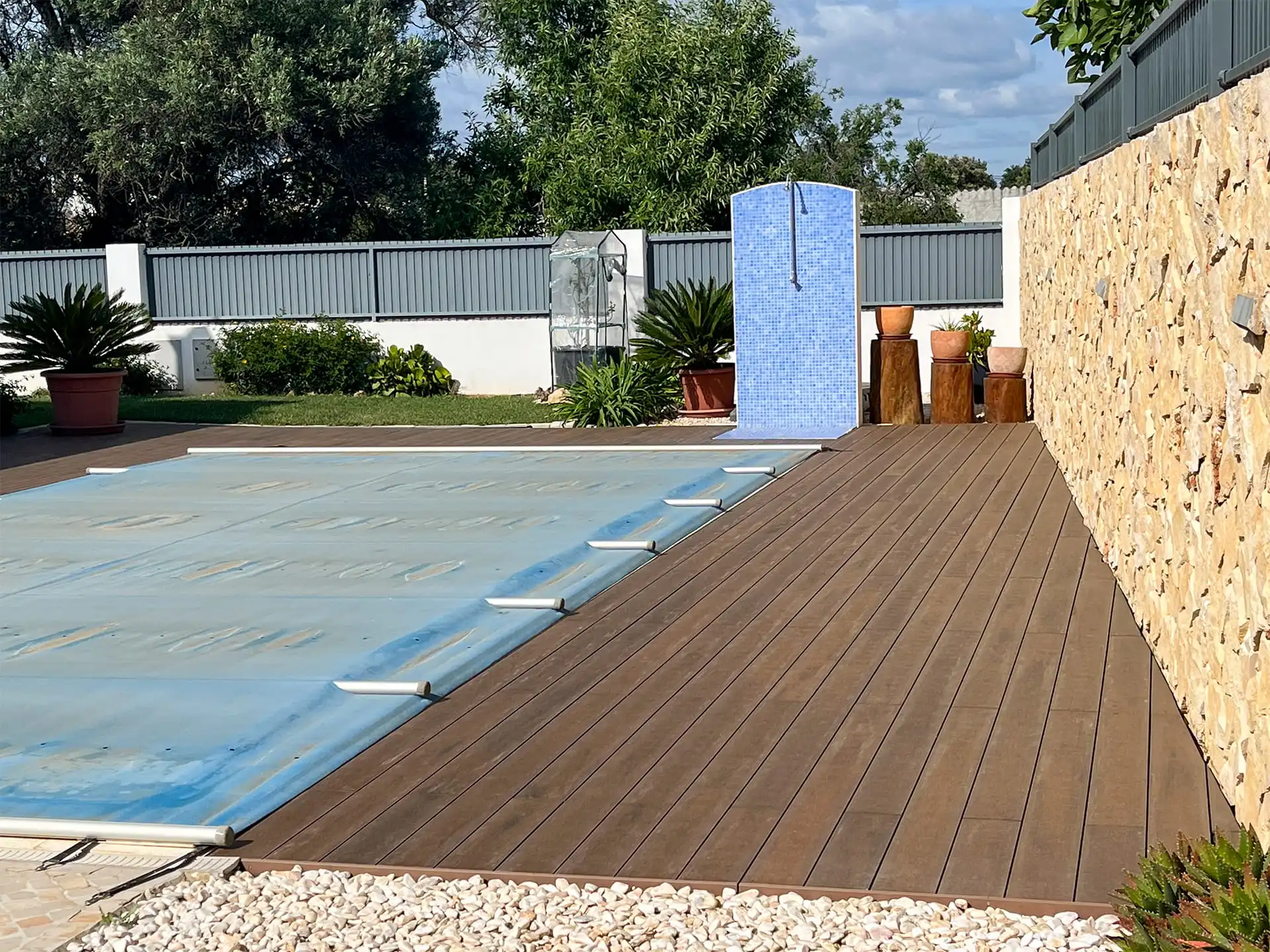 CDECK WUUDE composite decking in American Walnut color installed in a pool area in a house in the Algarve